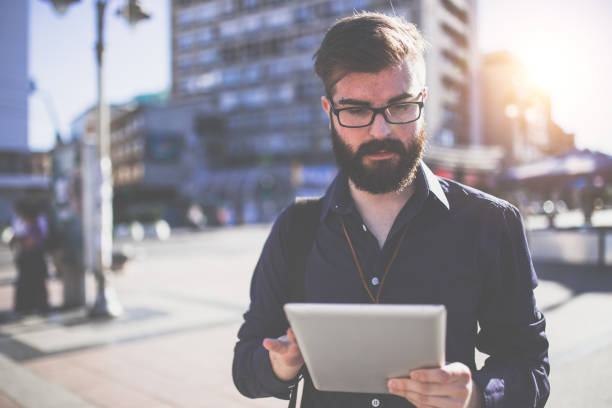 istock Hipster businessman looking at the tablet 610971812