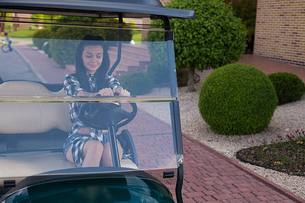 istock The woman is in a golf cart 610971852