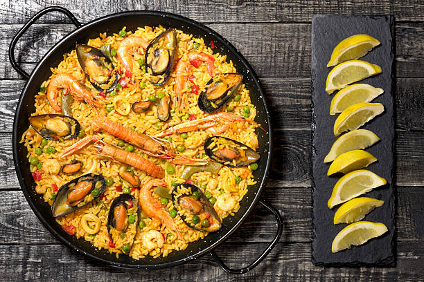 istock Spanish paella on a wooden table 610971876