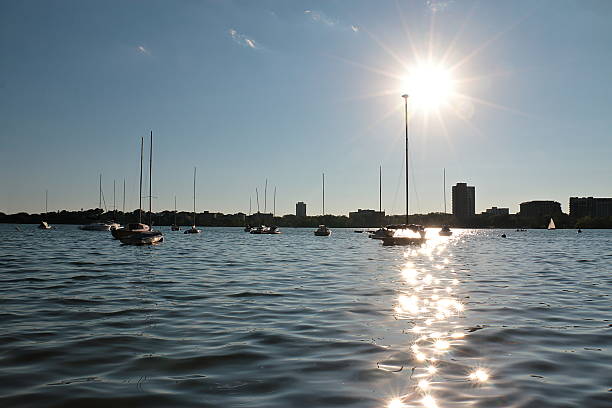 Sail boats are moored at the marina on Lake Calhoun against the setting sun in Minneapolis, Minnesota.