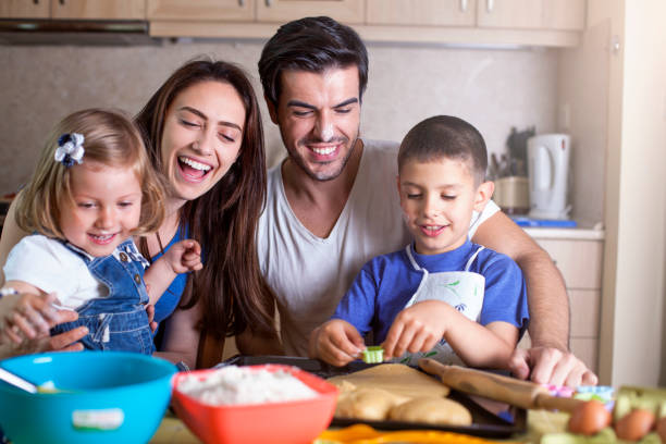 istock Happy family baking cookies 610973214