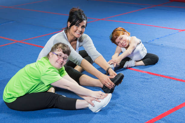 istock Fitness instructor working with special needs women 610973358