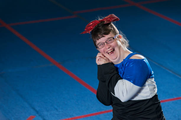 istock Young woman with down syndrome cheerleading 610973420