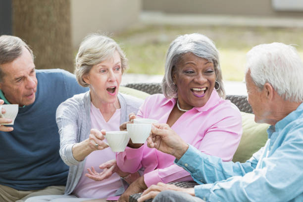 istock Multiracial senior friends outdoors drinking coffee 610973638