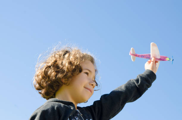 istock Young girl playing with toy plane 610973966