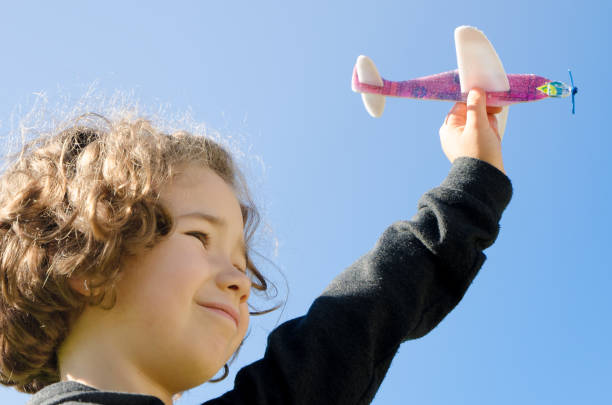 istock Young girl playing with toy plane 610974006