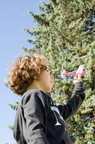 istock Young girl playing with toy plane 610974110