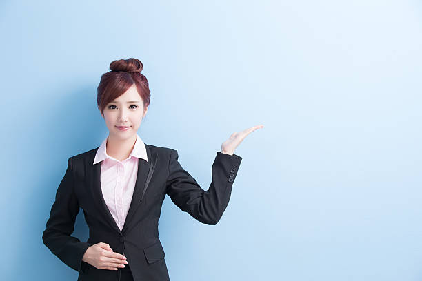 istock business woman show something 610976090