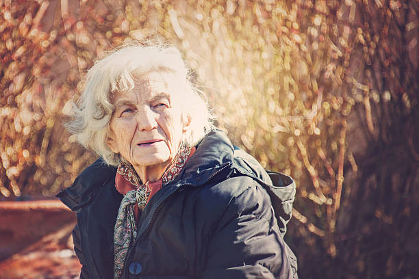 istock Beautiful Senior Woman Outdoors Lost in Thoughts 610976144