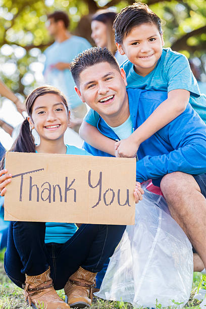 istock Happy Hispanic family help with community clean up 610977380