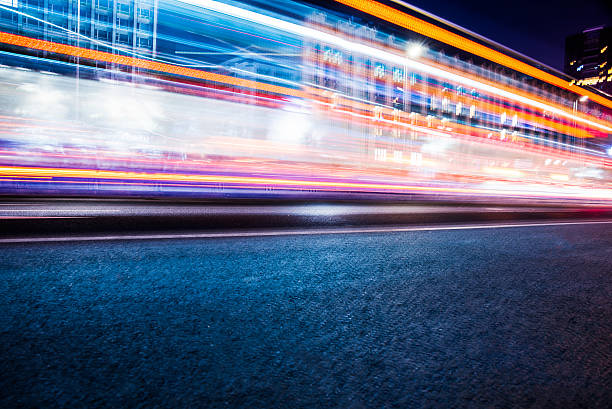 istock traffic light trails on urban street 610979904