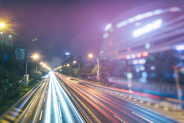 istock traffic light trails on urban street 610979984