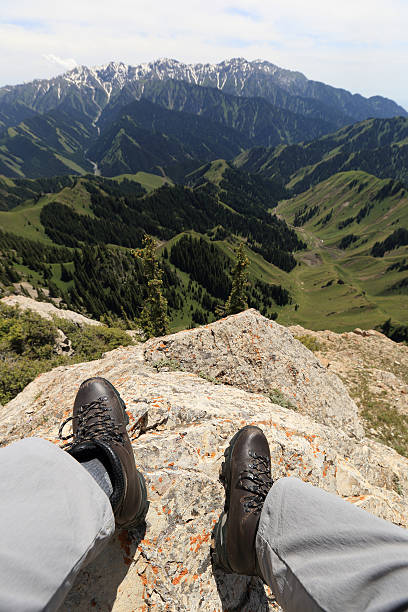 successful woman hiker hiking on mountain peak cliff