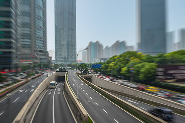 istock City road with moving car 610980664