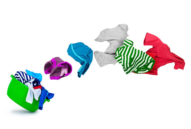 istock bright colorful clothes flying out from wash bowl on white 610981266