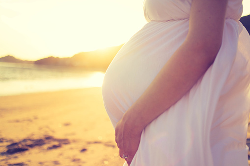 A Pregnant woman on the beach