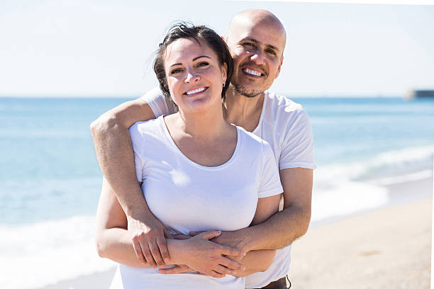 istock couple holding each other on the beach 610984940