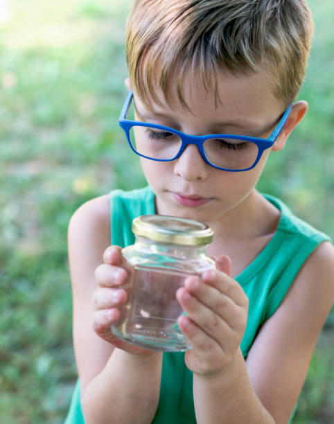 istock Child Looking in to a Jar 610986002