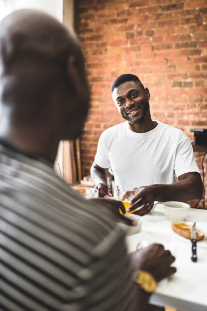 istock homosexual couple doing breakfast on the kitchen togetherness 610986038