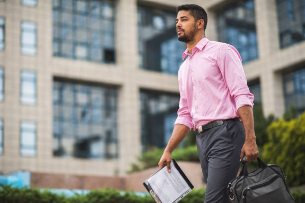 istock Young serious African American businessman going to work. 610987056