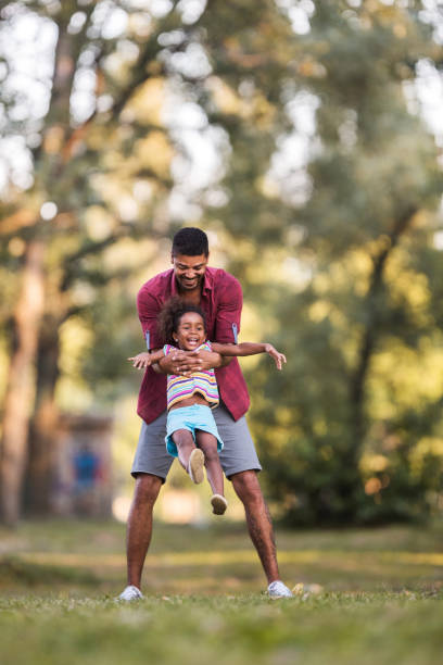 istock Happy father and daughter having fun in the park. 610988708