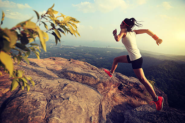 istock young woman trail runner running on mountain peak 610989820