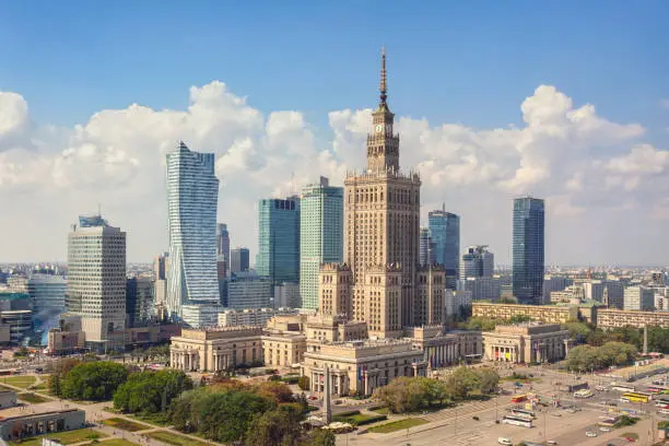 The skyline of central Warsaw at daytime. In the center stands the Palace of Culture and Science, an example of stalinist architecture from the 1950s.