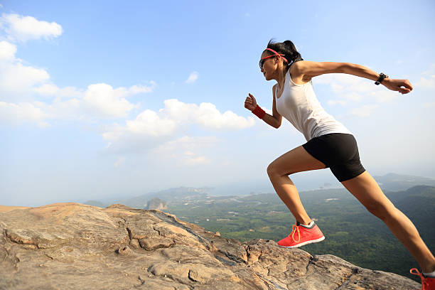 istock young woman trail runner running on mountain peak 610990140