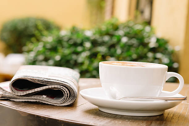 istock cup of coffee on the table with newspaper 610990336