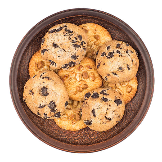 istock Cookies with peanuts and chocolate in a brown plate. 610990616