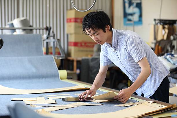 istock The senior tailor who designs jeans with a tablet 610991064