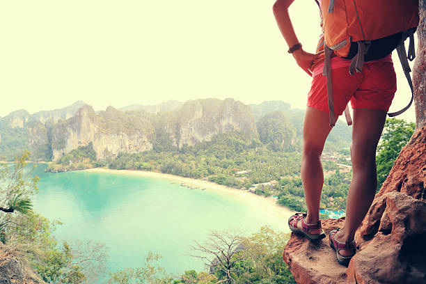 istock successful woman hiker enjoy the view on mountain top cliff 611063044