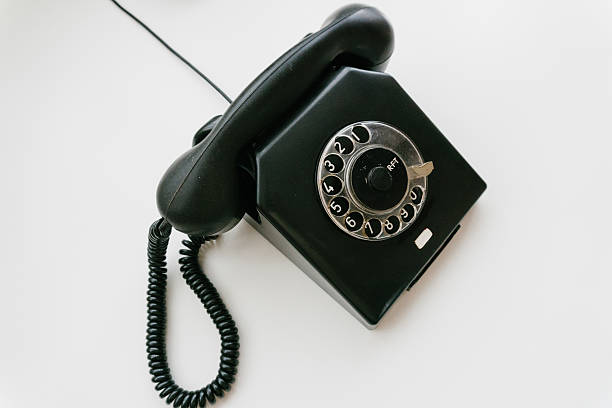 istock Black retro phone on a white background with rotary dial 611063320