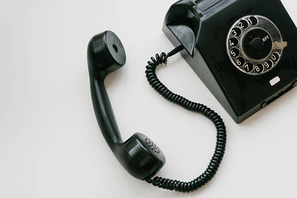 istock Black retro phone on a white background with rotary dial 611063492