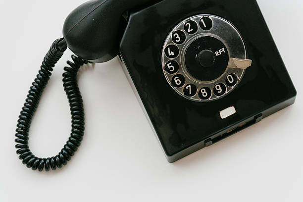 istock Black retro phone on a white background with rotary dial 611063638