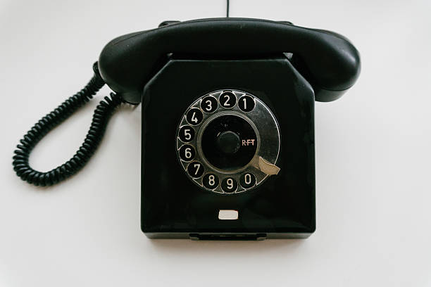 istock Black retro phone on a white background with rotary dial 611064250