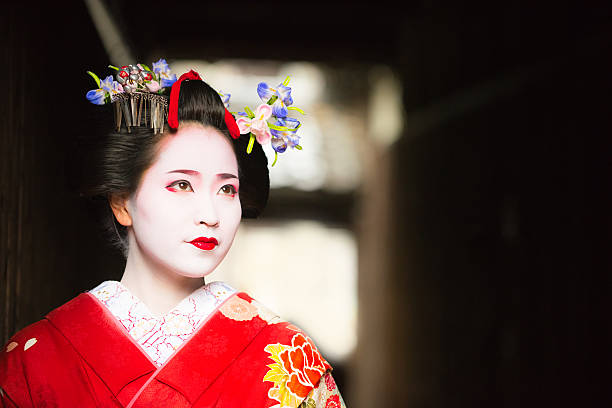 istock Maiko emerging into the light Gion Kyoto 611065238
