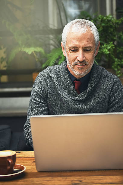 istock Getting some work done in his favourite coffee shop 611065438