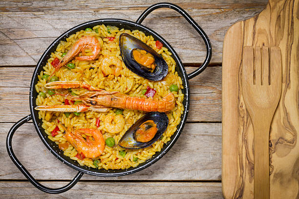 istock Spanish paella on a wooden table 611065458
