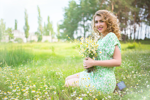 Beautiful woman portrait in flowers field
