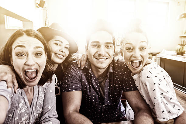 istock Young adults in bar taking selfie 611067402