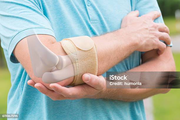 Man Wearing Elbow Brace Stock Photo - Download Image Now - Elbow, Tennis, Orthopaedic Brace