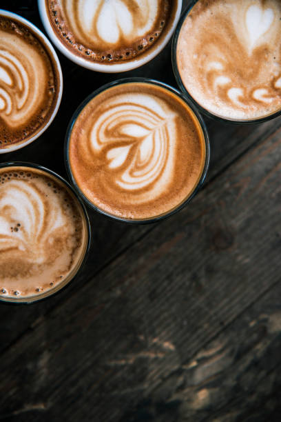 istock Close up of five coffies on a wooden table 611068040