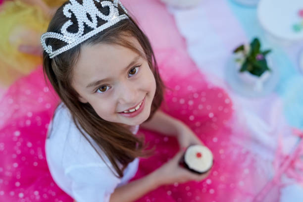 Excited little princess receiving gift from boy and smiling to him
