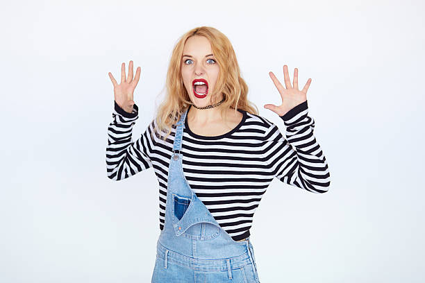 istock young woman screaming loud with angry emotions over white background 611068648