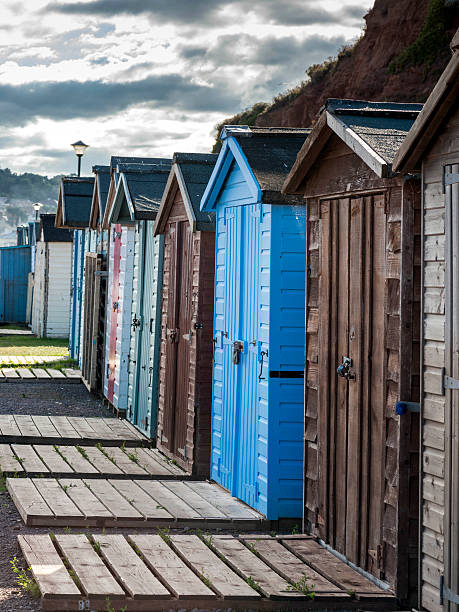 istock Seaside scene depicting a row of multicoloured beach huts, 611069586