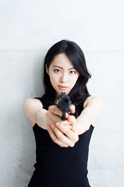 istock Japanese spy woman holding a gun 611069900