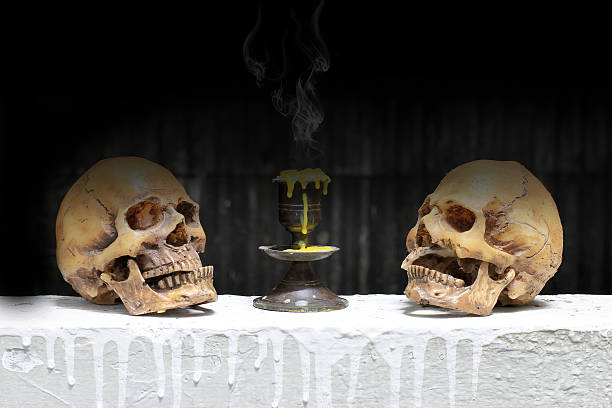 istock Old Human Skull in dim light dark night with smoke 611070016