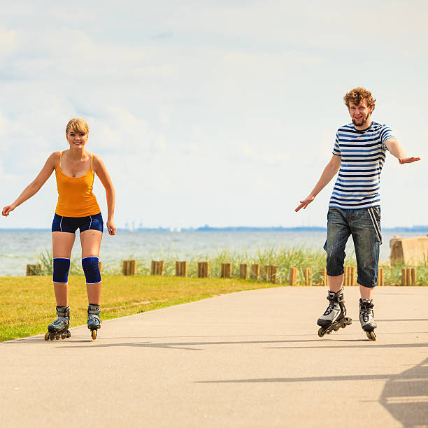 istock Young couple on roller skates riding outdoors 611070126
