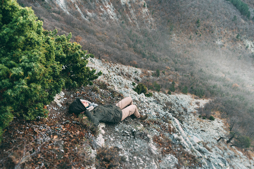 Hiker young woman resting in the mountains